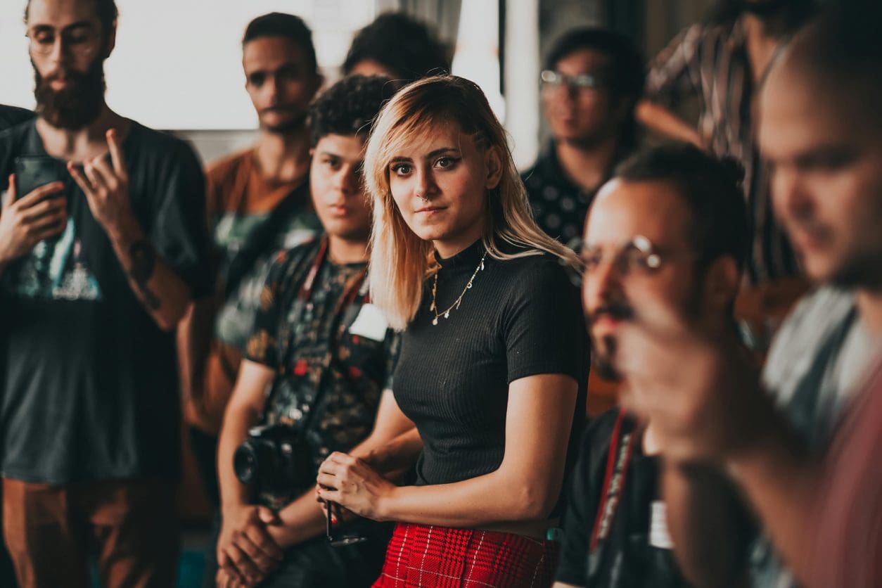 A woman standing in front of a group of people.